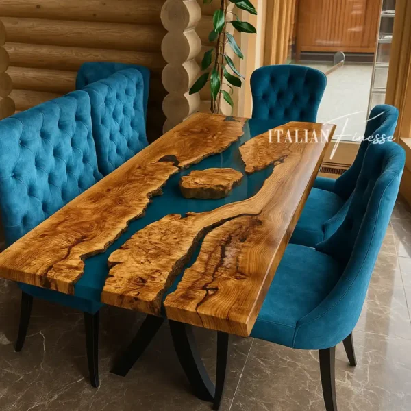 Tavolo in rovere massello con inserti in resina azzurra e isole in legno, gambe nere curve, ambientato in chalet con sedute in velluto blu.